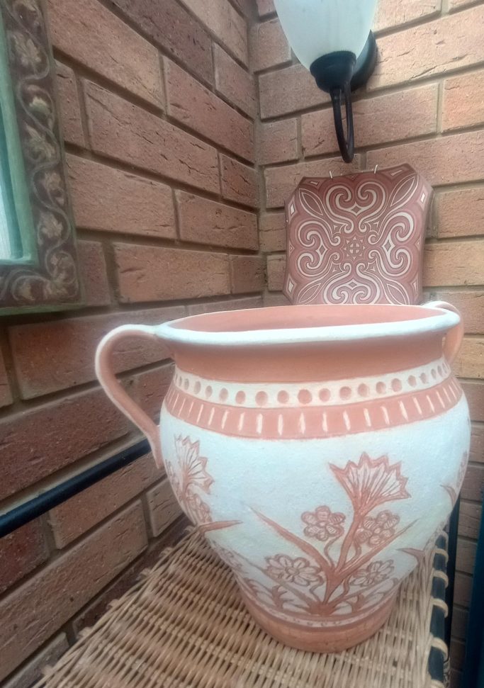 Unglazed terracotta pot (with terracotta swirl plate in background)